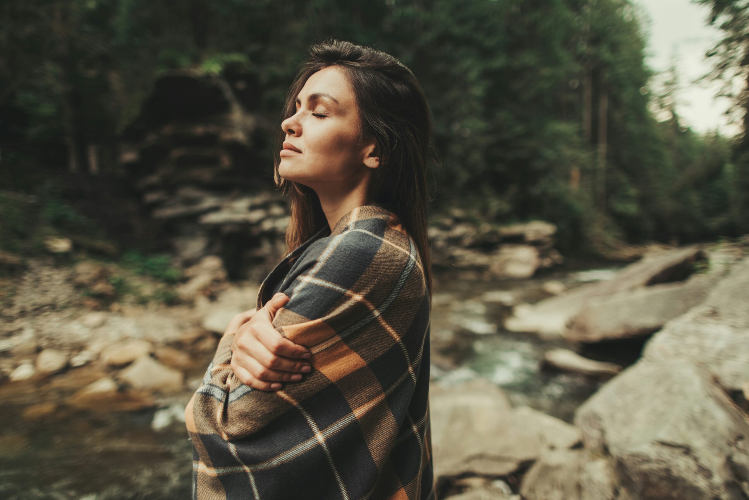Woman in nature practicing embodiment by a river, women’s retreat Time for Femininity Diana Richardson Jivan Dios