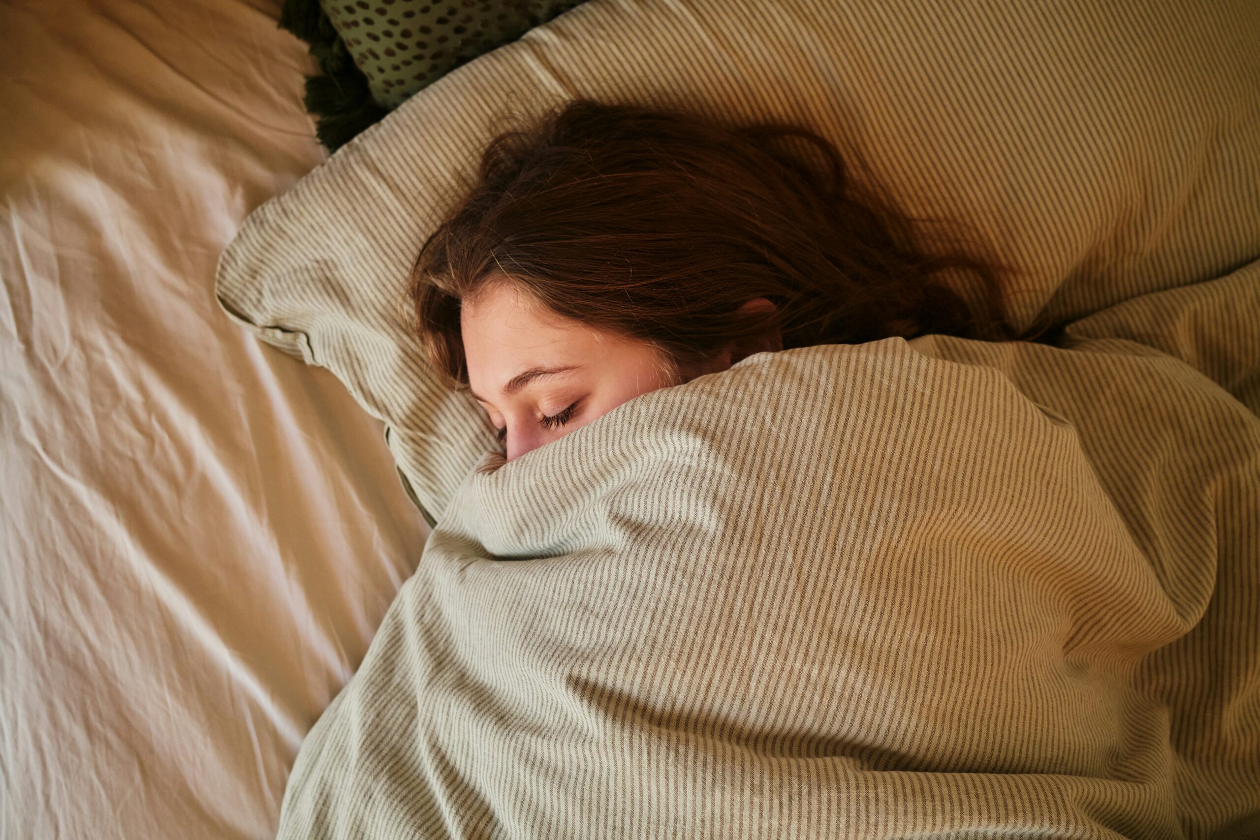 photo of tired woman lying in bed for jivan dios kindfulness blog couples therapy stockholm, women's workshops